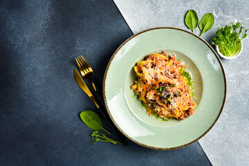 Traditional Bolognese pasta with meat and tomato paste. In a plate. Restaurant dish. Close up.