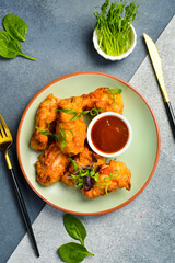 Buffalo chicken wings with sweet chili sauce. Close up. Top view.