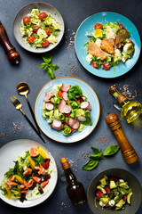 A set of vegetable dishes with seafood, veal and chicken. Top view.
