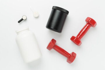 Jars with protein powder and dumbbells on color background, top view. Sports nutrition concept