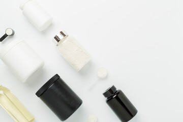 Jars with protein powder on color background, top view. Sports nutrition concept