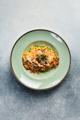 Homemade bolognese pasta. In a plate. Top view. Vertical photo.