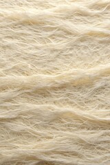 Obraz premium Textured beige fabric with visible fibers.