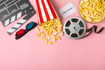 Tasty popcorn in buckets and cold cola drinks with cinema tickets, movie clapper and 3D eyeglasses...