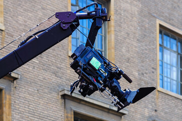 camera crane in front of a building