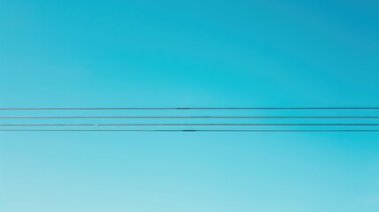 Electric cable in front of a clear blue sky