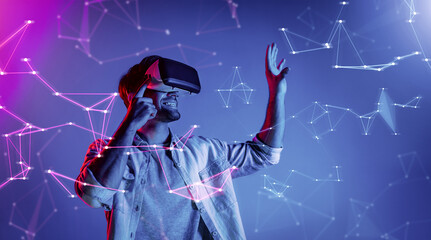 Smart man looking data or connecting with big data or virtual reality by using goggle or VR headset. Caucasian person exploring metaverse world and touching simulated program. Technology. Deviation.