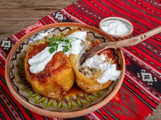 bell peppers stuffed with minced meat and served with sour cream, balkan / romanian cuisine