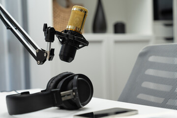 Modern office studio equipment microphone setting, laptop, tablet and headphone prepared with coffee on live streaming with empty host channel steamer podcast social media online concept. Postulate.