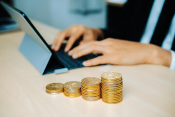 Fototapeta premium Businessman working with coin money currency. Concept of investment growth and money saving. uds