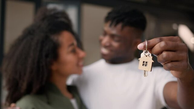 African American couple holding keys buying house own apartment happy family husband wife man woman homeowners hold key of new home moving day relocation real estate purchase bank credit loan mortgage