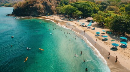 A lively beach scene with people swimming, sunbathing and water sports under umbrellas and on orange surfboards. 