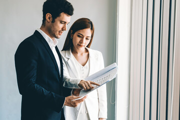 Businessman executive is in meeting discussion with businesswoman or client in modern workplace...
