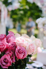 Red and pink roses flowers with valentine festival gift and beautiful blur bouquet background. Workshop in the park market. Copy space for your text.