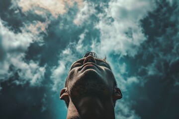 Man with tattoos looking upwards