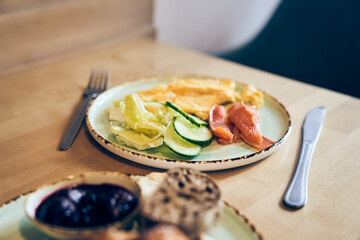 Omelet with salmon, avocado and cucumbers. With space to copy. Omelet with stuffing for breakfast. The concept of a healthy, ketogenic or carb-free diet. High quality photo