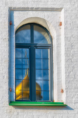 beautiful reflection of the dome of an ancient temple in the window. The Epiphany Staro-Golutvin...