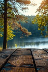 Obraz premium Peaceful lake scene at sunset with wooden bench, trees, and calm water. Perfect spot for relaxation or outdoor activities.