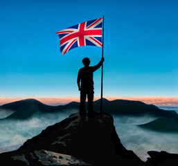 FLAG OF UNITED KINGDOM ON THE TOP OF A MOUNTAIN CONQUERING SUCCESS
