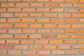 Brick wall background is a wall made of clay bricks, giving the structure strength and cement line between bricks that looks beautiful. It is popular to build a wall of ancient monuments.copy space,
