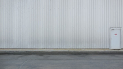 outer wall of a large warehouse with access doors for caregivers. The metal wall background of the...