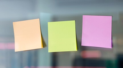 Empty sticky note papers on glass wall. Business planning concept. 