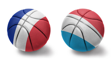 basketball balls with the national flags of luxembourg and france on the white background.