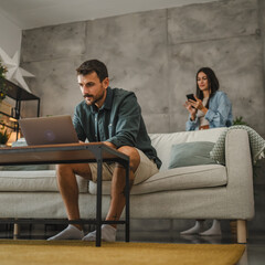 Adult caucasian man work from home and use laptop and papers