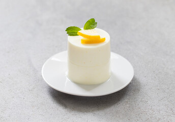 Modern dessert. Lemon cream pudding, Panna Cotta cylindrical shape. Close-up