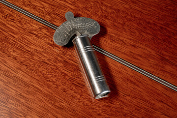 Vintage Variable metal chromatic guitar tuning pitch pipes resting on the back of an acoustic...