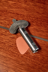 Vintage Variable metal chromatic guitar tuning pitch pipes resting on the back of an acoustic...