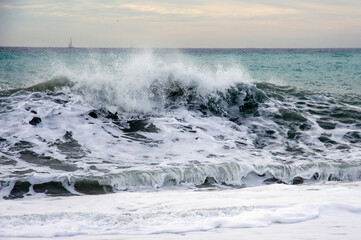 Waves of Bordighera sea at sunset. Bordighera is located 20 kilometres (12 mi) from the land border between Italy and France.
