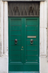 A green colored building door.
