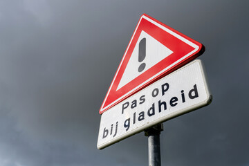 Dutch road sign: danger, be careful on slippery surfaces