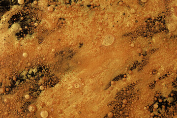 Abstract wave, bubble blot and drops background. Flow texture. Acrylic gold color in water and oil.