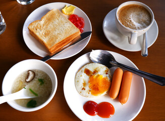 Morning breakfast with toast, coffee, fried eggs and sausage. Top view and close-up breakfast table. Concept of good meals, caffeinated drink, homemade, nutrition and energy. Breakfast background.