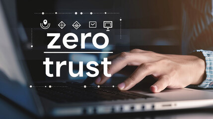  The hand of a business man using a laptop with security icons and the text "zero trust" on a virtual screen