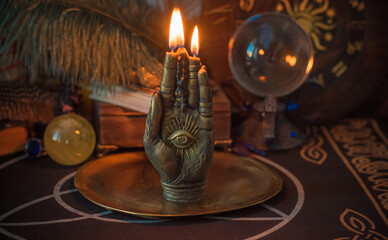 Candle burns on the altar, magic among candles, clean negative energy, esoteric concept	