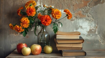 Stock photo of books, apples, and marigolds in a vase