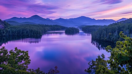 Fototapeta premium A tranquil lake reflecting a purple sunset sky framed by majestic mountains and lush forests