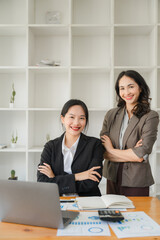 Diverse beautiful Asian girls working together in modern office Collaborate at a table with a laptop and participate in discussions