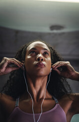 Fitness, music or face of woman in gym for commitment, determination or mindset for sport. Female athlete, earphones or serious with mockup for workout, thinking or drive from favorite song on radio