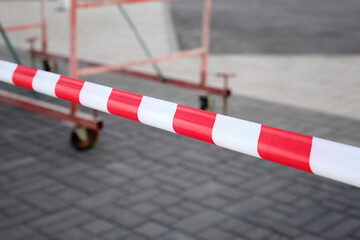 Close-up of barrier tape for fencing during construction or repair of roads in the city.