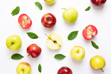 Many colorful apples on a white background. Summer food and vitamins concept. Top view