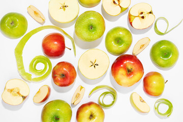 Many colorful apples on a white background. Summer food and vitamins concept. Top view