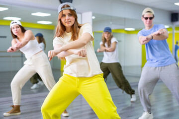 Fototapeta premium Focused teenages hip hop dancers doing dance workout during group class