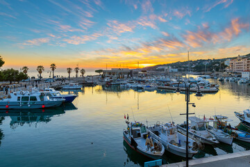 Fototapeta premium Colorful sunset skies above the Port de Cassis Marina along the Cote d'Azur, French Riviera, at the seaside village of Cassis, France.