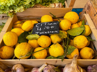 View of fresh ripe lemons citrus fruits in wooden box  on a farmers market in France high angle view