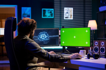 Computer scientist updating artificial intelligence machine learning algorithm on green screen PC....