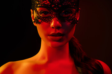 Cropped photo of tempting seductive woman naked shoulders lace bdsm mask isolated black red neon light background